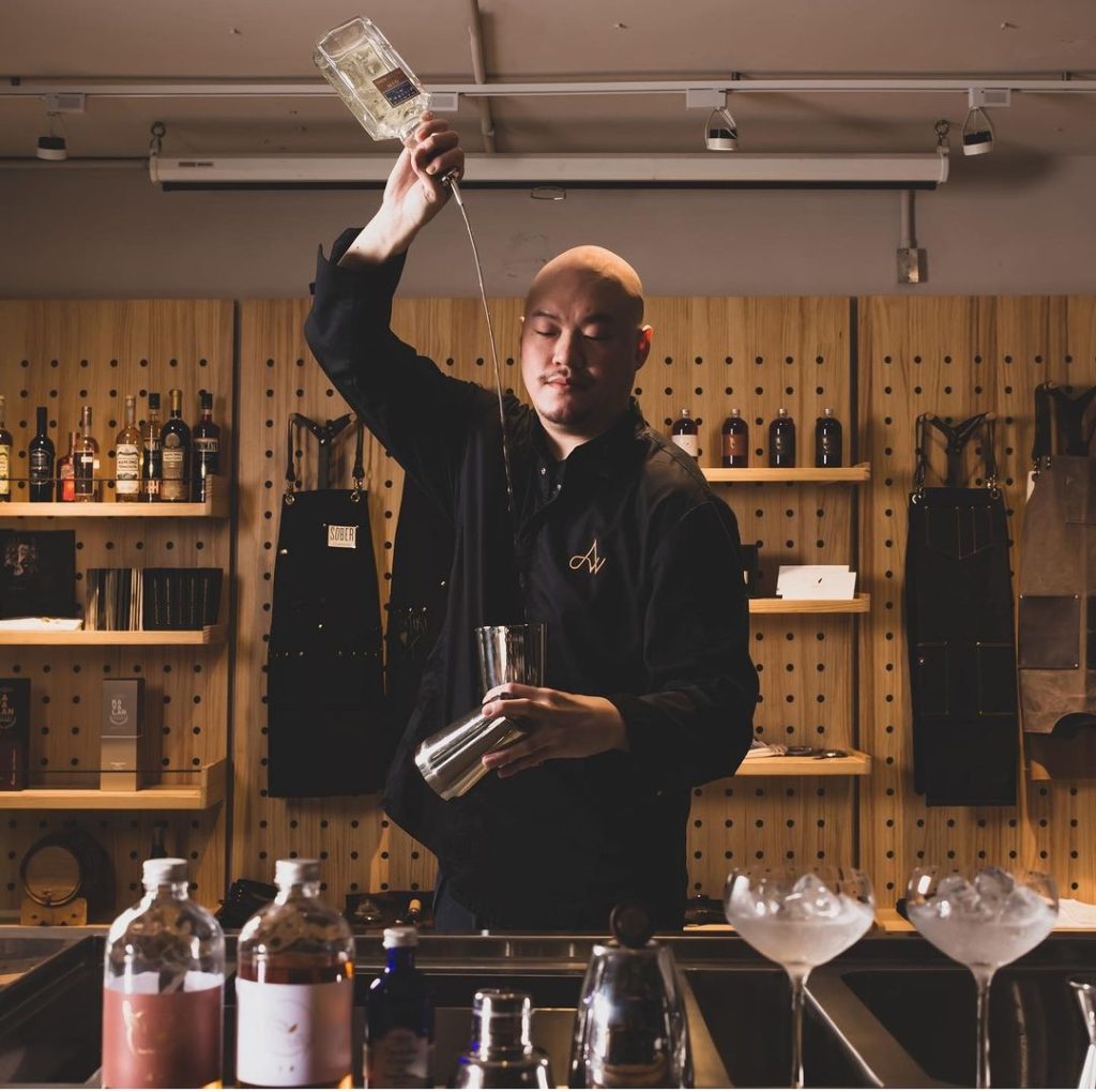 Aki Wang long pouring behind the bar.