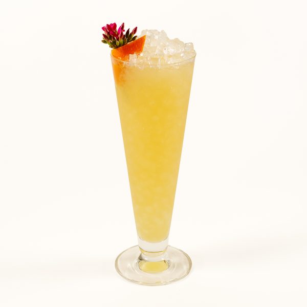 A tropical tiki cocktail with flower garnish.