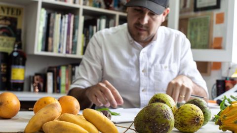 A man check some fruits on a table